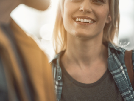 Happy female with smile telling with comrade. Optimistic communication concept. Close upの写真素材