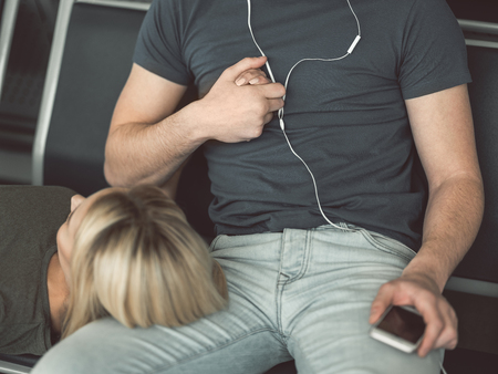Close up relaxed female holding man hand. He listening music. Love conceptの写真素材