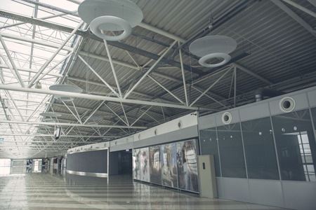 Wide hall of modern business center with unusual lamps on ceilingの写真素材