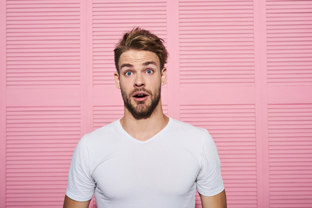 No way. Waist up portrait of amazed male standing and raising eyebrows in shock. He is looking with eyes and mouth widely open in wondermentの写真素材