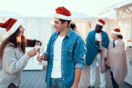 Side view outgoing man talking with beaming pretty girl. They tasting alcohol liquid during new year partyの写真素材
