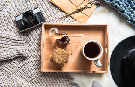 Top view cup of appetizing coffee with jars of jam locating in salver near gadget. Aroma conceptの写真素材