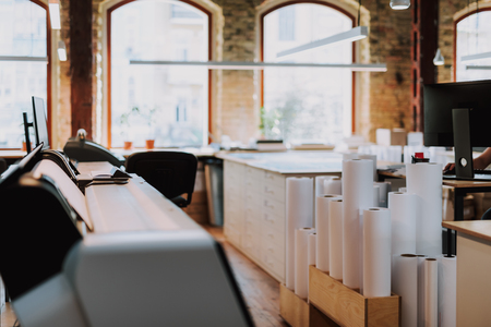 Paper rolls standing on the floor of typography with modern equipmentの写真素材