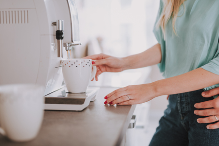 Close up photo of woman making coffee on the kitchenの写真素材
