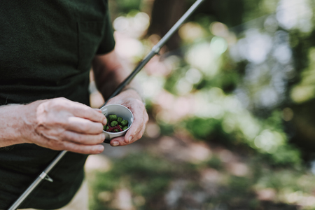 Close up of bait used for fishing in hands of a professional anglerの写真素材