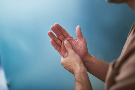 Healing procedure for my arms. Close up of gentleman massaging hands