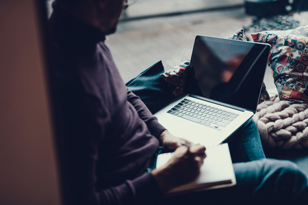 Cropped photo of mature man in sweater sitting in cafe near window.の写真素材