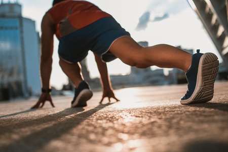Man preparing for running while turning back to camera. He standing in special pose