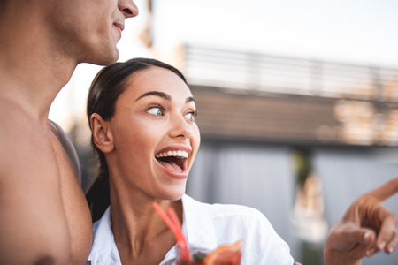 Feeling excited. Emotional young woman standing close to her boyfriend and opening her mouth while feeling excited and looking into the distanceの写真素材