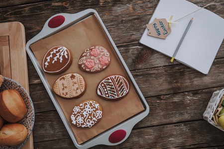 Preparing for Holly holiday. Top view portrait of Easter cookies with festive piping and opened...