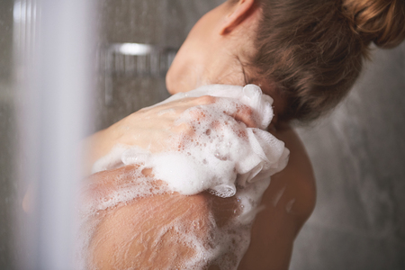 Young pretty lady enjoying shower at homeの写真素材