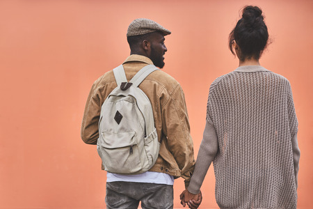 Rear view of nice couple holding hands of each otherの写真素材