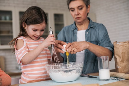 Cropped photo of granddaughter preparing for Easter with her granny at home