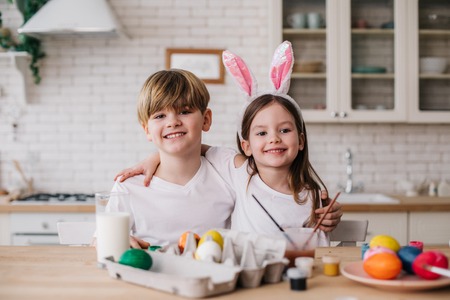 Smiling cute children posing for camera in kitchenの写真素材