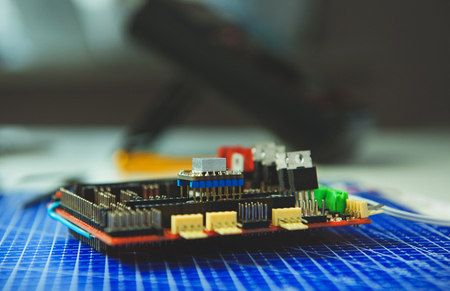 Side view of microcircuit lying on blue board