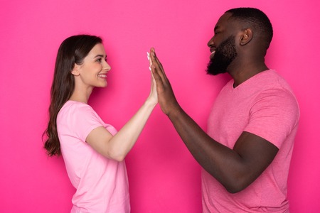 Close up of smiling interracial couple looking at each other in studio