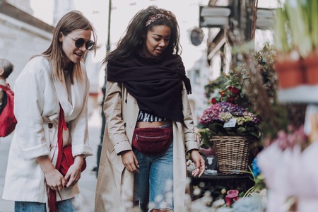 Two beautiful young women spending time together outdoorsの写真素材