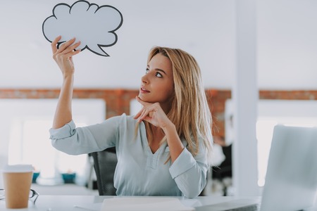 Curious woman putting thought cloud near her head