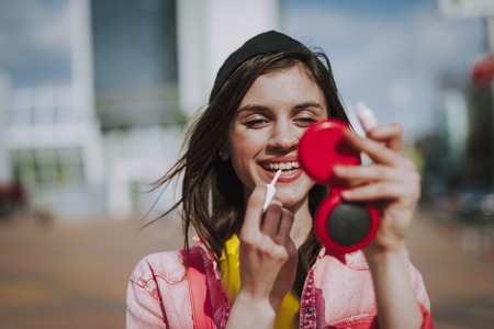 Pretty smiling hipster girl refreshing make upの写真素材