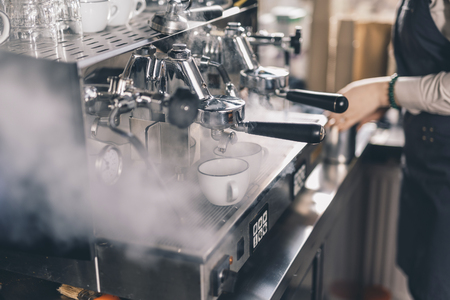Steam near the group espresso machine in the cafeの写真素材