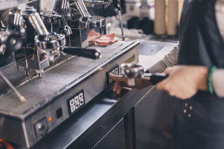 Close up of barista using group espresso machineの写真素材