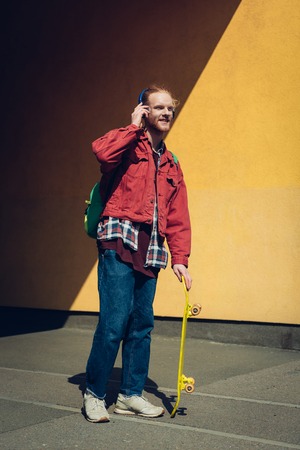 Hipster skater man with headphones on head