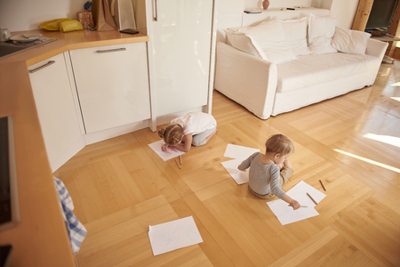 Adorable kids drawing with colored pencils at homeの写真素材