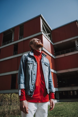 Young happy hipster man enjoying sunny weatherの写真素材