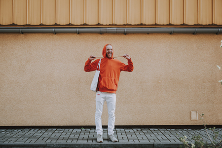 Happy smiling hipster man having fun on walkの写真素材