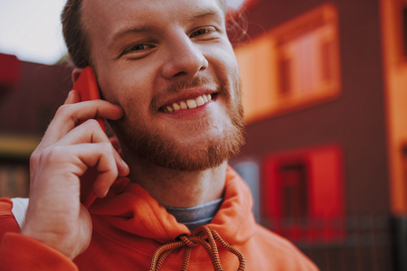 Happy hipster man talking by phone outdoorの写真素材