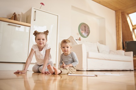 Adorable children drawing with pencils at homeの写真素材