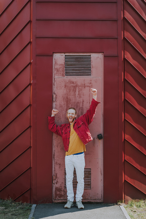Happy excited hipster man on worn out door viewの写真素材