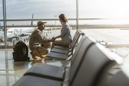 Soldier situating opposite his spouse and promising to come back home aliveの写真素材