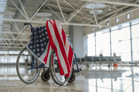 Low angle of wheelchair covered with American flagの写真素材
