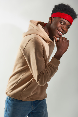 Happy Afro American guy posing in studio on white backgroundの写真素材