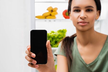 Smiling brunette lady with mobile phone in handの写真素材