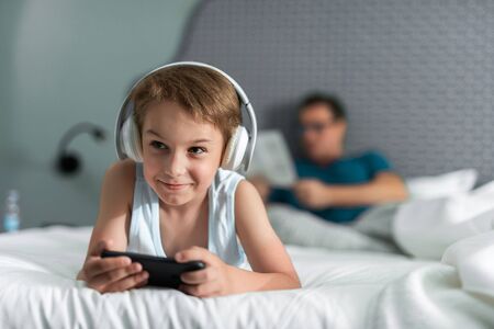 Little boy in headphones listening to musicの写真素材