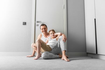 Father and little son having fun together at homeの写真素材