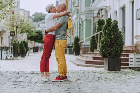 Smiling adult man and woman walking outdoorsの写真素材