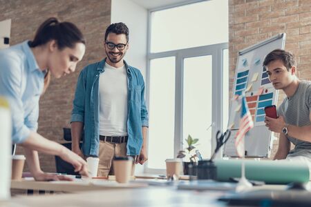 Males and female employees talking about start-up project