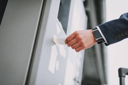 Businessman hand is paying for parking outdoorsの写真素材