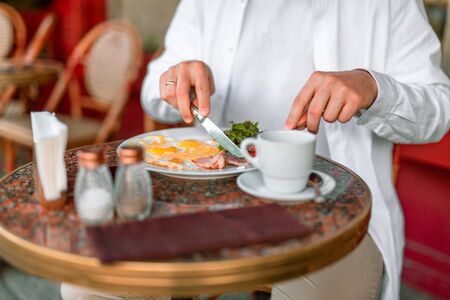 Close up of man having breakfast in a cafe