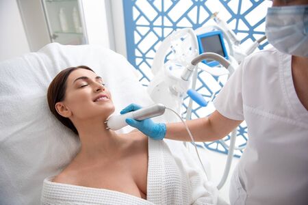 Woman on anti-age procedure of neck zone