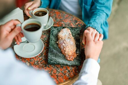 Romantic couple sitting at the table in outdoor cafeの写真素材