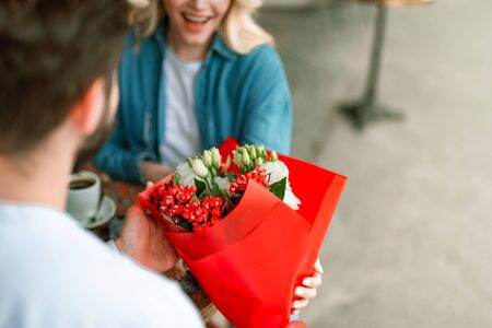 Beautiful flowers in the hands of kind loving guyの写真素材