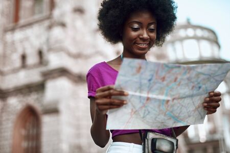 Smiling afro-american woman standing in the cityの写真素材