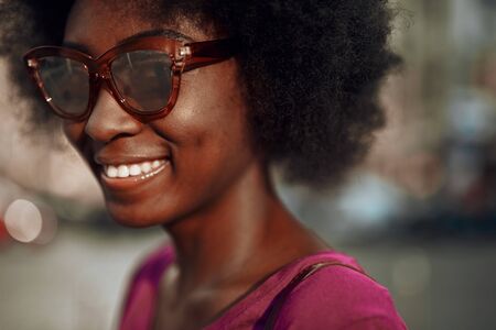 Beautiful afro-american lady looking at camera and smiling