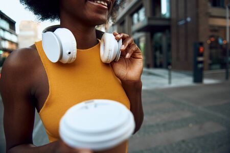 Smiling afro-american woman with hot drink in handの写真素材