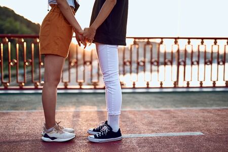 Young beloved couple staying together on sunsetの写真素材