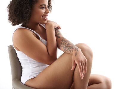 Gorgeous Afro American woman with curly hair posing for camera